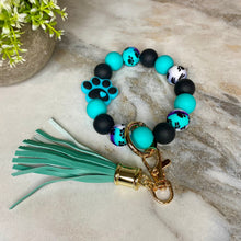 Load image into Gallery viewer, Silicone Bracelet Keychain - Paw Print Teal Swirl
